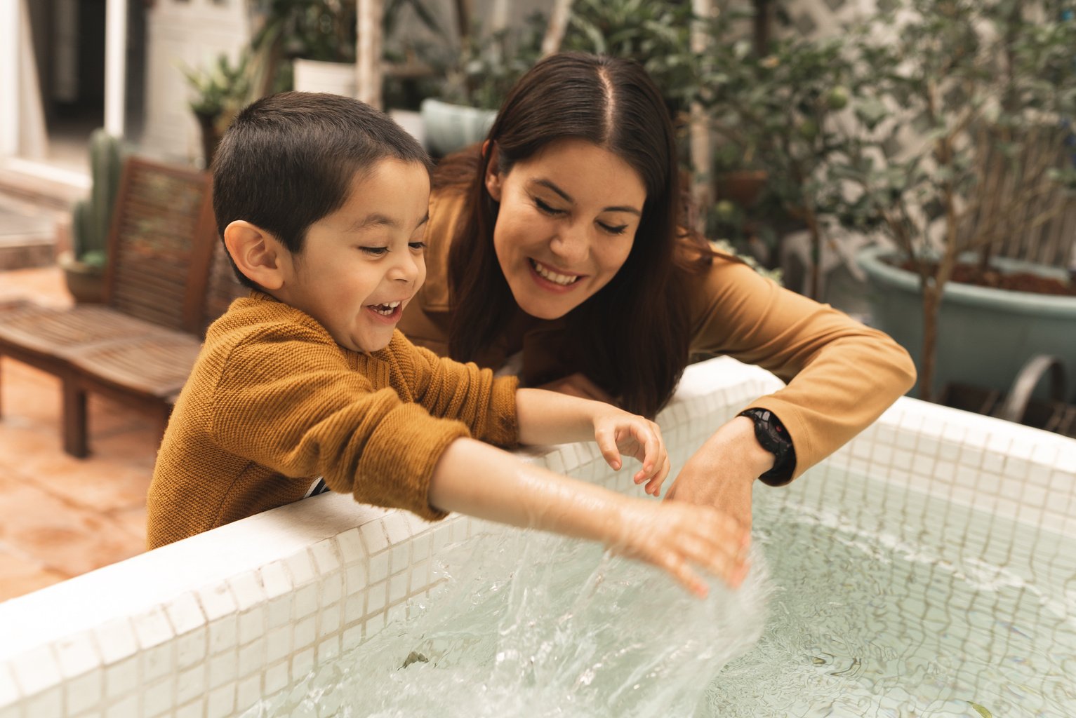 Girl with Autism and Her Mother Playing with Water